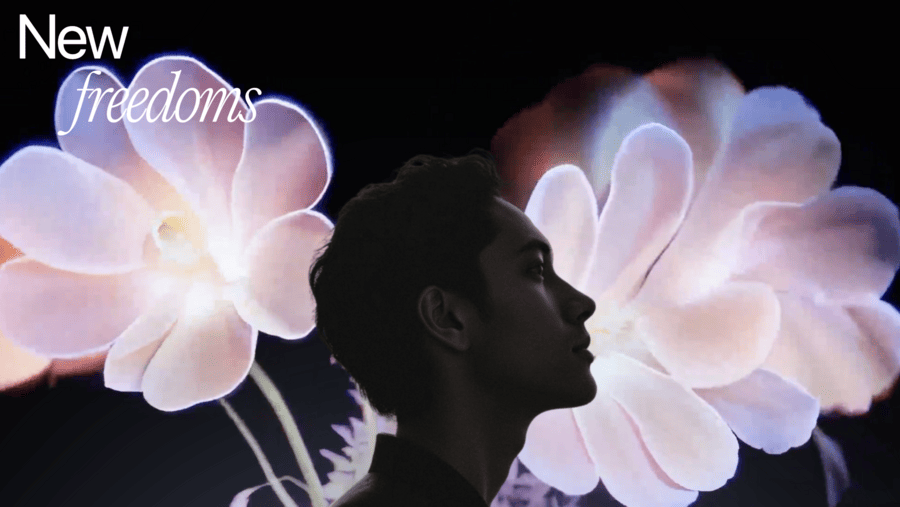 a man looking up at a flower
